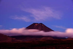 Landscape paintings Jigsaw Puzzle Collection: Mount Ngauruhoe peak of perfectly shaped volcanoe Mt Ngauruhoe sticking out of clouds at dusk