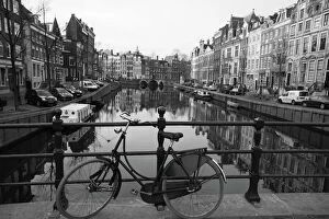 Bicycle Collection: Black and white imge of an old bicycle by the Singel canal, Amsterdam, Netherlands