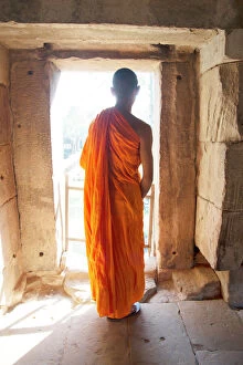 Angkor Photo Mug Collection: A Buddhist monk exploring the Angkor Archaeological Complex, UNESCO World Heritage Site