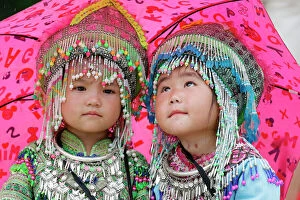 Focus On Foreground Collection: Hmong children under umbrella in the monsoon (rainy) season, Sapa, Vietnam, Indochina