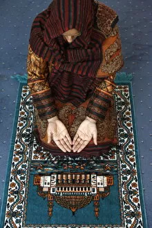 Related Images Metal Print Collection: Muslim woman kneeling on prayer mat saying prayers, Jordan, Middle East