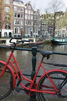 Bicycle Collection: Red bicycle by the Herengracht canal, Amsterdam, Netherlands, Europe