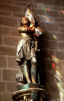 Interior Collection: Statue of St. Joan of Arc with coloured light from stained glass, Church of Notre Dame