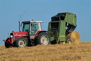 Harvesting Collection: Tractor towing baler unloading drum bale, Wannock, Sussex, England, United Kingdom