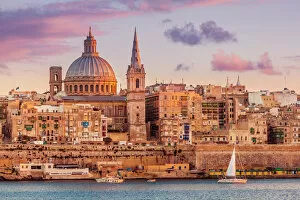 Cultural festivals and traditions Pillow Collection: Valletta skyline at sunset with the Carmelite Church dome and St