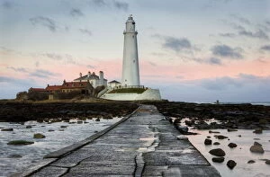 Journey Collection: View along the tidal causeway to St. Marys Island and St. Marys Lighthouse at dusk