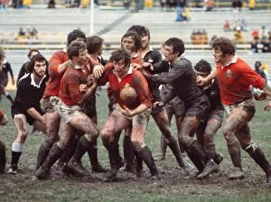 Rugby Framed Print Collection: The British Lions and Junior All Blacks clash in the mud in 1977