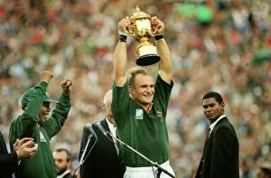 Springbok Collection: Francois Pienaar lifts the World Cup for South Africa as Nelson Mandela cheers