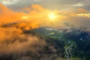 Rivers Fine Art Print Collection: Aerial view of sun rays in the sunset sky lighting up the clouds over Romsdalen valley