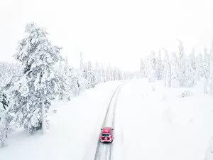 White Jigsaw Puzzle Collection: Elevated view of car along the snowy road in the icy forest, Pallas-Yllastunturi