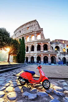 Misc Fine Art Print Collection: Italy, Rome, a red Vespa motorbike in front of Colosseum at sunrise