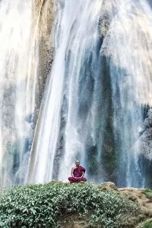 Matteo Colombo Collection: Myanmar, Mandalay division, Pyin Oo Lwin. Burmese monk meditating under Dattawgyaik Waterfall