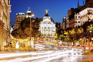Matteo Colombo Collection: Spain, Madrid. Street view with Metropolis building and light trails