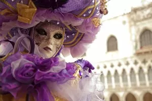 C Ulture Collection: Venice, Veneto, Italy; A masked character in front of the Palazzo dei Dogi during Carnival