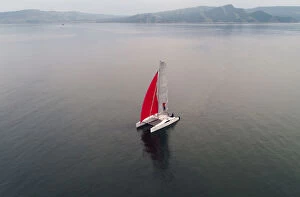 Aerial Views Photographic Print Collection: Aerial view shows a couple traveling on a sailing catamaran along the Yenisei River