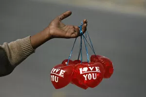 Love Jigsaw Puzzle Collection: A boy holds Valentines Day balloons for sale along the roadside in Lahore