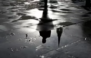 Dailylife Metal Print Collection: The Palace of Westminster and a man walking are reflected in a puddle in London
