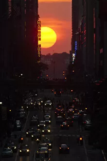 Sunlight Collection: People make their way through 42nd street at sunset, during the Manhattanhenge in