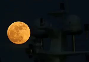 Super Moon Collection: A supermoon full moon rises behind the antennae domes on a motor yacht in Pieta