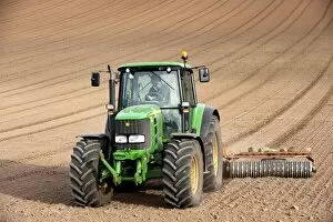 Press Collection: John Deere tractor pulling soil press, rolling seedbed in arable field, Kelso, Scottish Borders