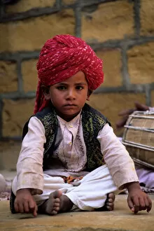 Model Release Collection: India, Rajasthan, Jaisalmer. Boy dancer rests between songs at entrance to Jaisalmer Fort