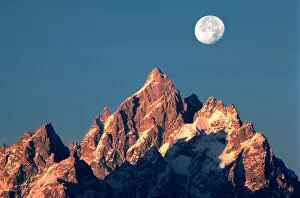 Ric Ergenbright Collection: USA, Wyoming, Grand Teton NP. A full moon sets behind the Grand Teton peaks in Grand Teton NP