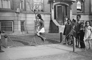 Related Images Framed Print Collection: CHICAGO: CHILDREN, 1941. Children jumping rope outside of an apartment building