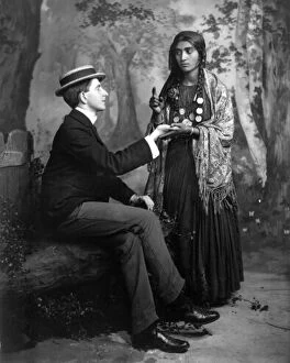 Shawl Collection: PALM-READING, c1910. A staged depiction of a Gypsy woman reading a mans palm. Photographed c1910