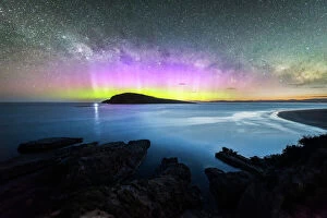 Blue Hour Collection: Colourful display of the Aurora Australis over an island in the ocean at Blue Hour