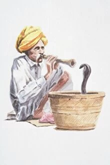 Snake Charmers Collection: Snake charmer playing flute-like instrument, snake emerging from basket in front