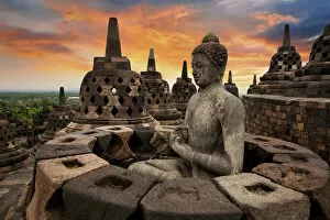 Central Java Province Collection: Sunrise with a Buddha Statue with the Hand Position of Dharmachakra Mudra in Borobudur, Magelang