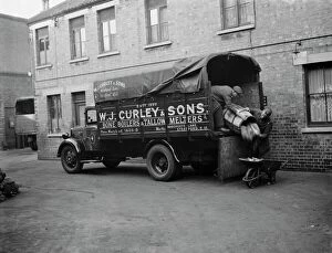 Building Collection: Men unloading bones and animal waste from a WJ Curleys lorry at Stratford, East London