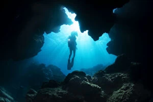 Dave Fleetham Underwater Photography Collection: Diver exploring cavern, Yap, Micronesia