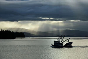 MIichael Melford Photographic Print Collection: A fishing boat motors through the Inside Passage