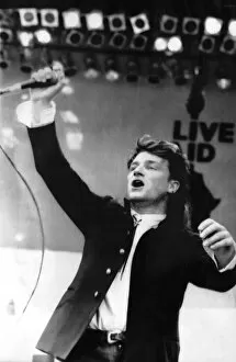 Live Aid Concert, Wembley 1985 Metal Print Collection: Bono lead singer from the top Irish band U2 Dublins answer to Bruce Springsteen rocks to