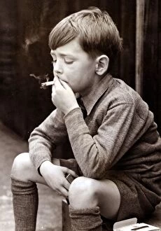 Related Images Jigsaw Puzzle Collection: Naughty boy smoking a cigarette, circa 1950
